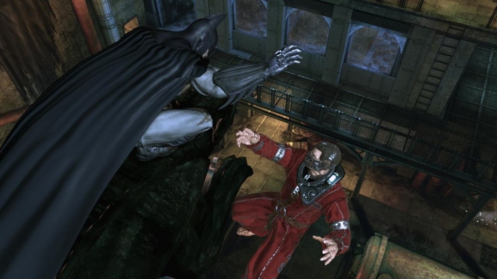 Batman: Arkham Asylum: The Caped Crusader about to drop a bad guy off a buidling.