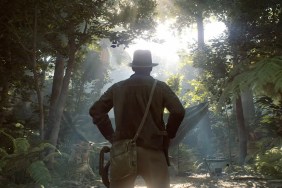 The back of Indiana Jones as he looks out into a dense forest.