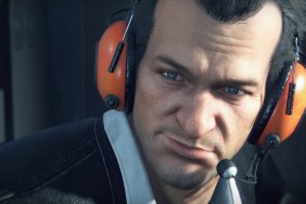 Dead Rising Deluxe Remaster: A close-up of Frank West wearing orange ear defenders.