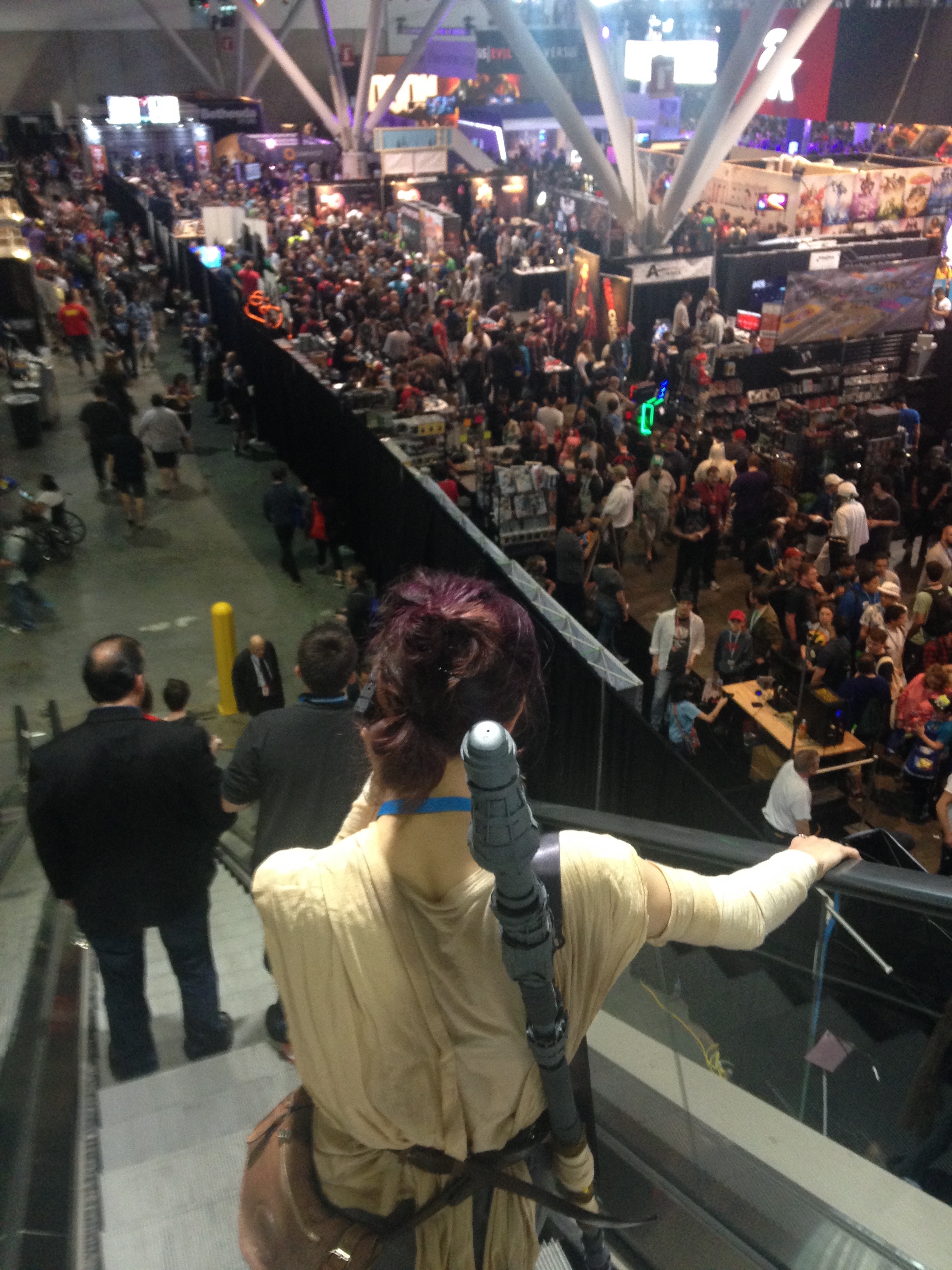 Rey looks over the crowd while taking a call